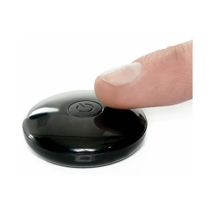 A close-up image showing a fingertip pressing the small power symbol on the surface of the Pipedream Products' Fetish Fantasy Vibrating 8 Inch Hollow Dildo & Strap-on Harness w/ Remote - Chocolate against a white background. This discreet gadget aids those dealing with erectile dysfunction.