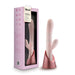 The Fraya Thrusting Shaft Powerful Rabbit Vibrator in pale pink, designed by Blush, stands elegantly on a rose gold base. This premium silicone vibrator features a curved shaft and clitoral stimulator, offering thrusting vibration modes for heightened pleasure. Accompanying it is the pink packaging that bears the "Blush" brand and product details, with a window showcasing the toy inside.