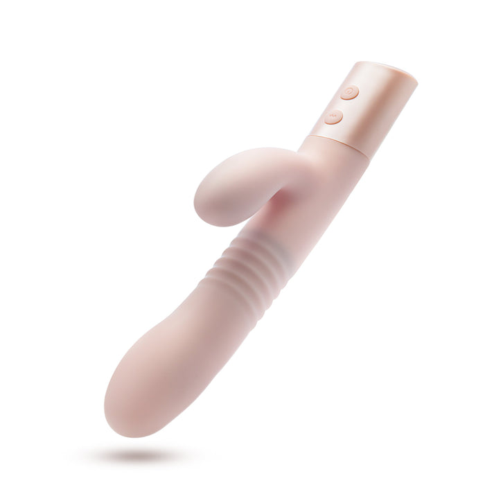 The Fraya Thrusting Shaft Powerful Rabbit Vibrator by Blush is a pale pink, battery-operated personal massager made from premium silicone. It boasts a smooth, curved design with ribbed texture near the base and features a flexible extension with two control buttons on the handle. The clitoral stimulator seamlessly floats against a plain white background.