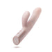 The Blush Fraya Thrusting Shaft Powerful Rabbit Vibrator in Pale Pink is a dual-stimulation vibrator crafted from premium silicone. It features a ribbed shaft for added sensation and a clitoral arm. The ergonomic handle includes two buttons located near the bottom, adjacent to a magnetic charging port with two metal contacts, all in a smooth, curved design.