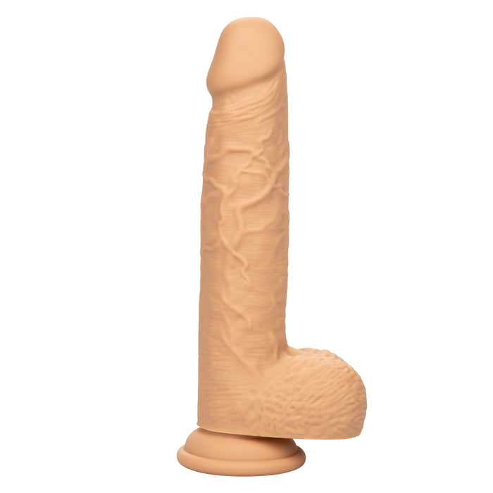 The CalExotics Fuck Stick Squirting Vibrating Silicone Suction Cup Dildo in Vanilla is a realistic dildo designed to resemble a human penis with detailed features. It has a flesh-colored, veiny texture and comes with a suction base for hands-free use. This strap-on harness compatible dildo is set against a white background.