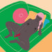 Illustration of a nude person with dark skin and pink hair, lying on a green sofa. They have their eyes closed and are using a Fun Factory Big Boss Thick Vibrator in pink, which is USB rechargeable, in one hand. The background features a pink round pillow with a sun design and a yellow square pillow.