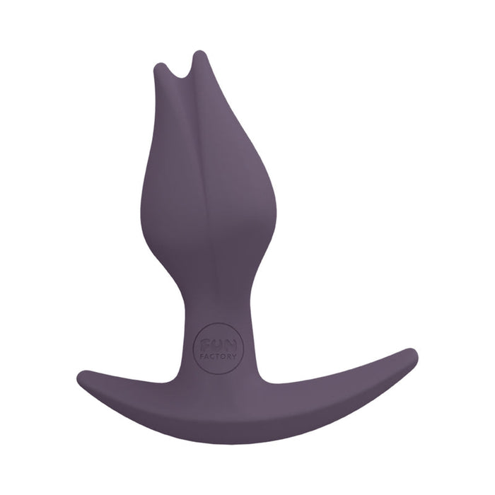 The Fun Factory Bootie Fem Anal Plug - Purple is an ergonomic anal plug, featuring a smooth, tapered head for easy insertion and a wide, curved base for safety. Crafted from body-safe silicone and stamped with the brand name "Fun Factory," it is perfect for those interested in double penetration experiences.