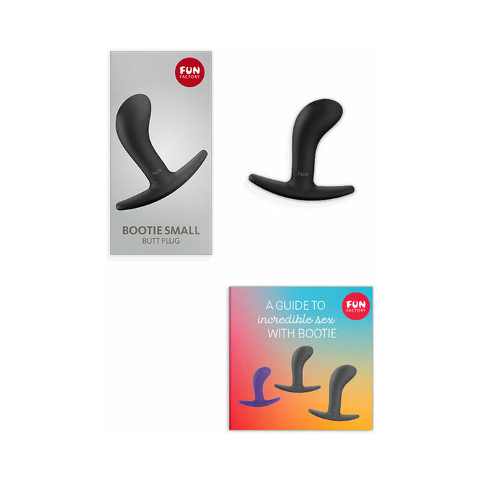 Image shows a Fun Factory Bootie Small Silicone Anal & Prostate Plug product package, a black silicone Bootie Small Silicone Anal & Prostate Plug beside the package, and a booklet titled "A Guide to Incredible Sex with Bootie," featuring three different sizes of the waterproof anal toy on a gradient background.