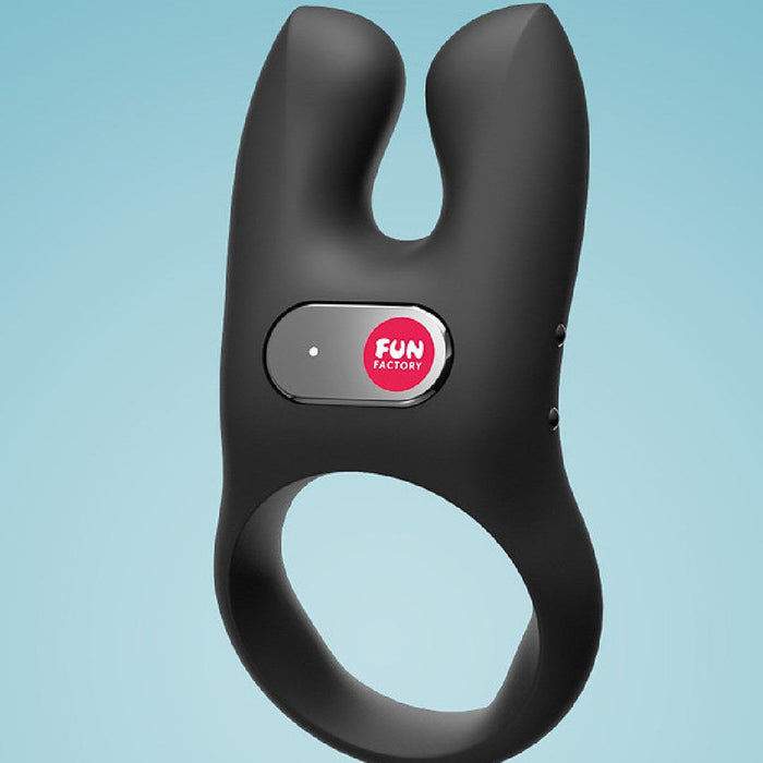 Fun Factory NŌS Vibrating Couples Penis Ring - Black angled side view on blue background