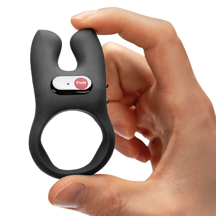 Fun Factory NŌS Vibrating Couples Penis Ring - Black held in a hand on a white background