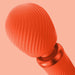 Close-up of the Fun Factory Vim Silicone Weighted Rumbly Wand Vibrator in orange, showcasing its modern, textured design and deep-reaching vibrations. Positioned against a matching orange background, the vibrator's smooth and ribbed surface is prominently highlighted.