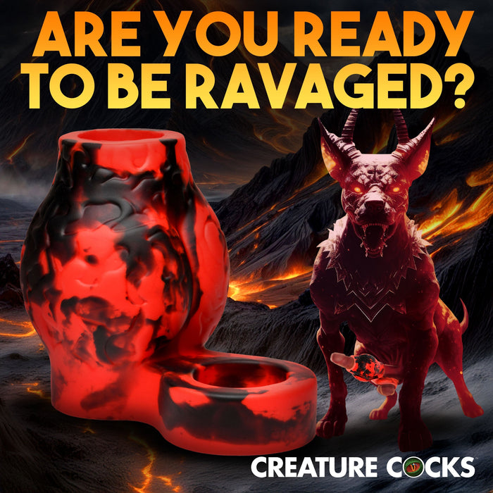 A Hell Hound Canine Knot Girth Enhancer with Ball Strap from XR Brands, swirled in red and black silicone, appears next to a mythical wolf-like creature with glowing red eyes. The background features a fiery, volcanic landscape. Bold yellow text at the top reads, "ARE YOU READY TO BE RAVAGED?" while "CREATURE COCKS" is displayed at the bottom.