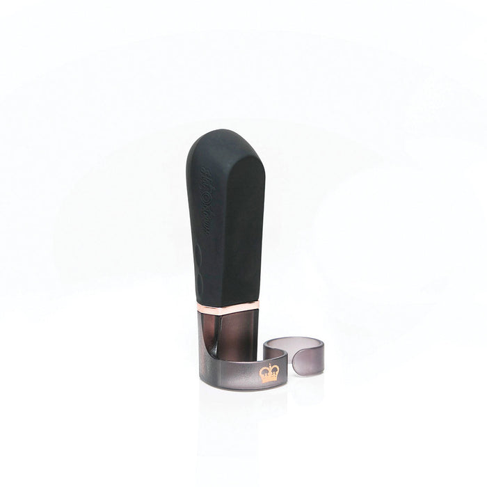 A black and brown alto saxophone mouthpiece is standing upright on a white background. A metal ligature with a crown logo is loosely attached at the base of the mouthpiece, resembling the sleek design of the Hot Octopuss Digit Silicone Rechargeable Finger Vibrator. The overall background is clean and minimalist.