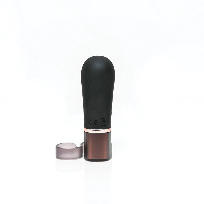 The Hot Octopuss Digit Silicone Rechargeable Finger Vibrator, resembling a black lip balm, stands upright against a white background. The cap is partially removed and placed beside the base. Crafted from premium silicone with certification markings on its metallic part, it exudes quality and style.