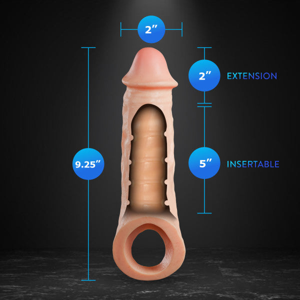 An image of the Intrepid 2 Inch Veiny Silicone Penis Extender with Ball Strap by Blush, measuring 9.25 inches in total length, with a 2-inch extension and 5 inches as the insertable length. The silicone enhancer is displayed vertically against a dark background, showcasing its realistic veins and dimensions highlighted in blue text.