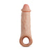 The Intrepid 2 Inch Veiny Silicone Penis Extender with Ball Strap by Blush is a flesh-toned, realistic silicone phallic-shaped extension sleeve. Made from Dual Density Platinum Cured Liquid Silicone, it features detailed texture and realistic veins with a hole at the base.