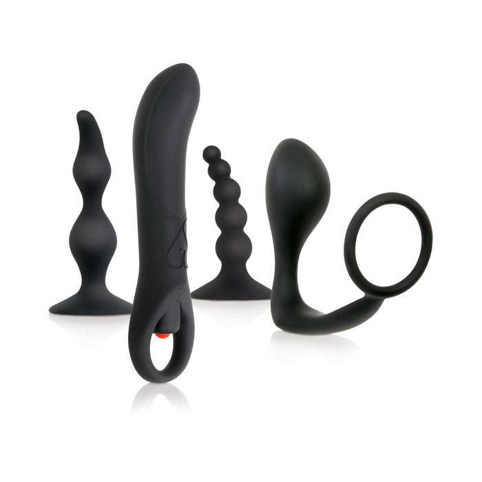 A collection of Evolved Novelties' Intro To Prostate Kit 4 Piece Silicone - Black, featuring variously shaped and textured adult toys like plugs and rings, along with a vibrating prostate massager, displayed against a white background.