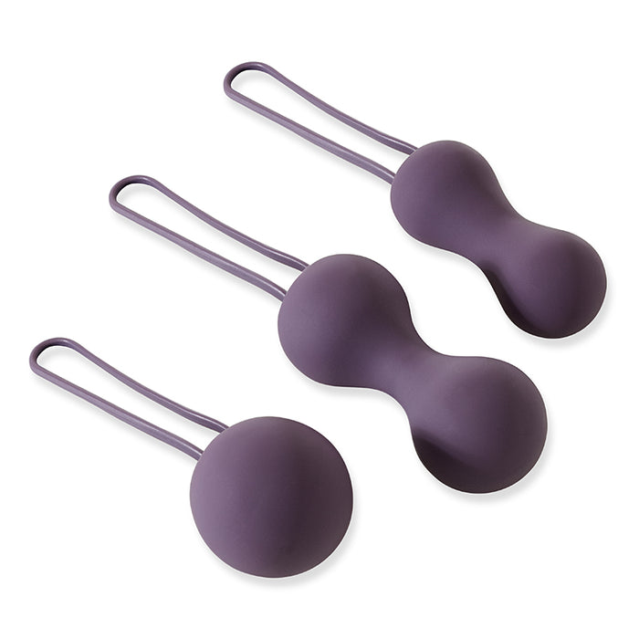 The Je Joue Ami Kegel Ball Exerciser Set in purple includes three silicone balls of different shapes, each with a smooth surface and sturdy loop for easy removal. This expertly designed system effectively strengthens pelvic floor muscles.