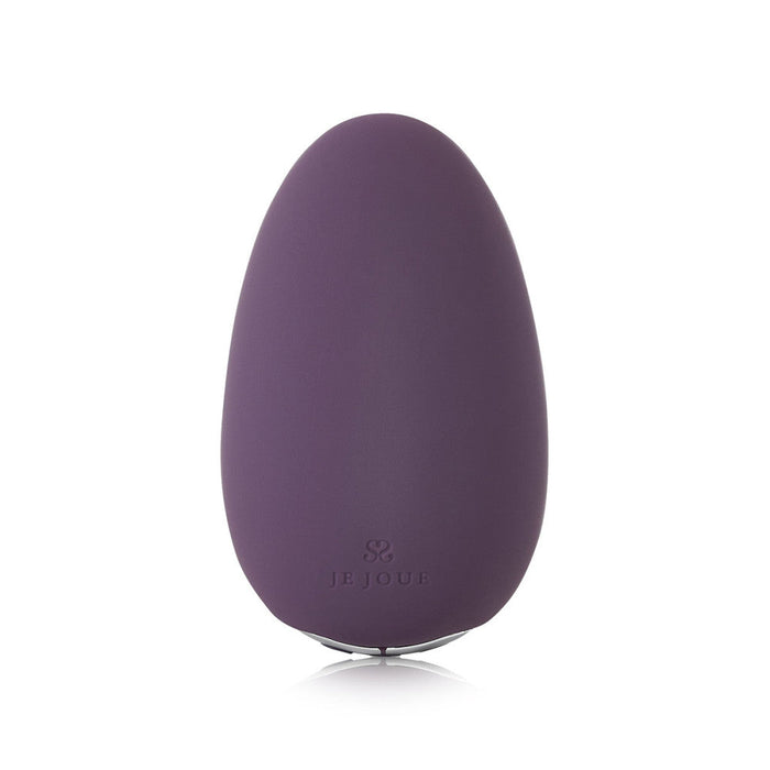 The Je Joue Mimi Clitoral and External Vibrator in purple is an egg-shaped personal massager with a smooth surface and a small base. The brand name "Je Joue" is engraved near the bottom. This USB rechargeable device has a simple, modern design, offers multiple vibration speeds, and appears to be made of silicone.