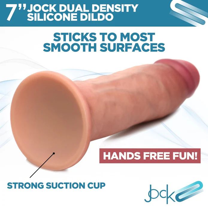 The image displays the Jock Dual Density Silicone Thick 7 Inch Dildo in Vanilla by XR Brands. It features a robust suction cup base for adhering to smooth surfaces. The text highlights "Sticks to Most Smooth Surfaces," "Hands Free Fun!," and the brand name "Jock.