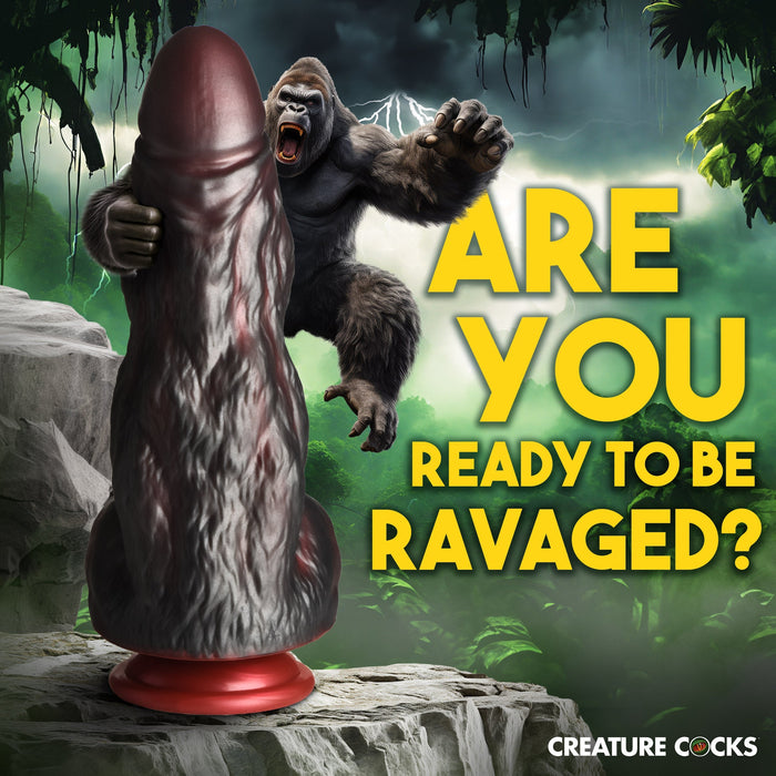 A gorilla is depicted in a lush jungle setting, dramatically posed mid-air with an extended arm. In the foreground, there's a large, King Kong Thick 9 Inch Silicone Gorilla Dildo shaped black object with a red base and high-quality silicone construction by XR Brands. Bold yellow text reads, "ARE YOU READY TO BE RAVAGED?" and "CREATURE COCKS" appears at the bottom.