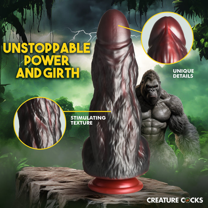 A promotional image for the high-quality silicone fantasy-themed erotic toy named "King Kong Thick 9 Inch Silicone Gorilla Dildo" by XR Brands. The dildo, which resembles a gorilla in texture and design, is showcased on a wooden platform with a jungle background and a gorilla in the distance. Text highlights its unique details, stimulating texture, and suction cup base.