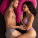 Heterosexual white couple laying against Liberator Arie Toy Mount Spooning Pillow - Pink