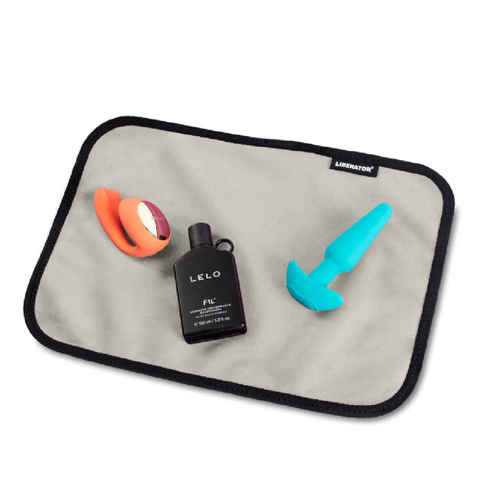 Liberator Fascinator Toy Pad Mini Waterproof Sex Blanket - Grey  with toys on it 