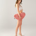 Dark haired model holding Liberator Faux Fur Heart Wedge Sex Positioning Cushion - Pink