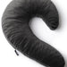 A dark gray, C-shaped pillow viewed from above. The sumptuous velvet fabric adds a touch of luxury, and a small black tag is attached to its side. Designed with supportive shredded memory foam, the Liberator Lune Toy Mount Sex Pillow - Black by Liberator offers ergonomic comfort and sophisticated style.