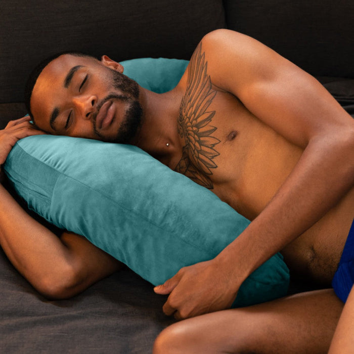 Black male model laying against Liberator Lune Toy Mount Sex  Pillow - Teal