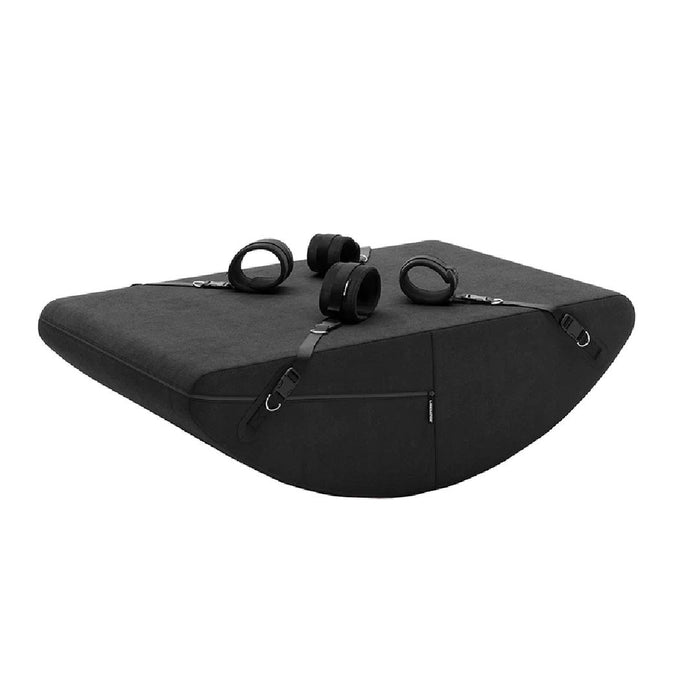 The Liberator Scoop Rocker Wedge with Cuffs - Black, reminiscent of the Liberator Scoop Rocker, features rounded corners and four detachable straps with circular handles. Ideal for both fitness routines and intimate positioning cushion for bedroom adventures, its smooth fabric surface includes small side pockets.