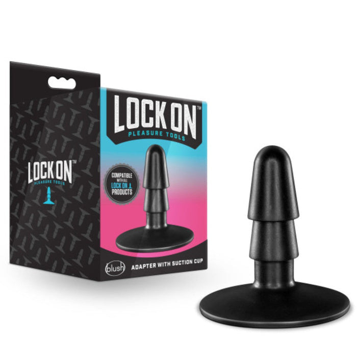 A Blush lock on dildo packaging box alongside the toy, which includes a Lock On Adapter with Suction Cup (Vac U Lock Compatible), depicted on a white background.