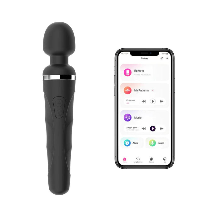 A black Lovense Domi 2 Powerful App Controlled Wand Vibrator, featuring a curved handle and buttons on the grip, is placed next to a smartphone. The smartphone screen displays a Bluetooth-compatible control app with options for remote, my patterns, music, alarm, and more.