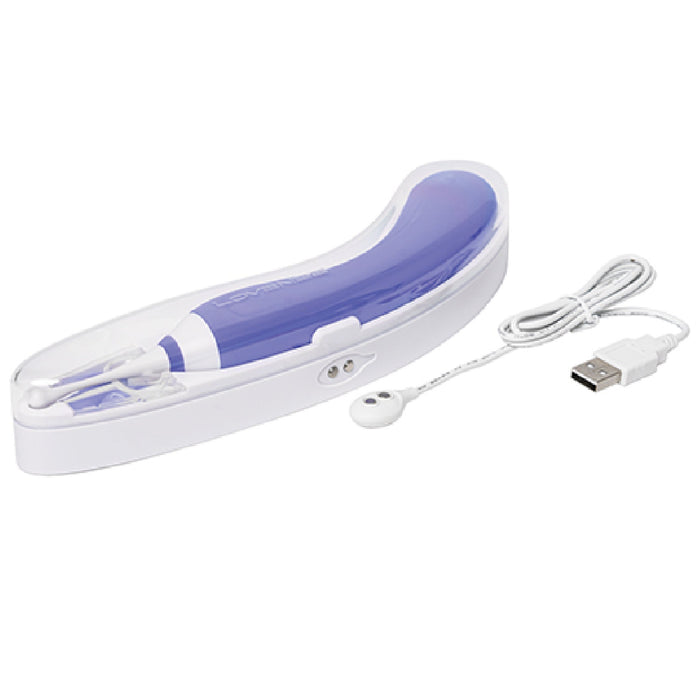 A sleek, purple Lovense Hyphy Dual Ended High Frequency Vibrator with an oscillating tip and clear cap lies next to a detachable white USB charging cable. The device features a transparent cover and a small power button, designed for enhanced pleasure and precise stimulation.