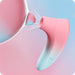 The Lovense Tenera 2 Bluetooth Clitoral Air Stimulator by Lovense, featuring a pink and blue gradient silicone design, emits a gentle white stream of air or light towards a semi-transparent circular object, set against a matching background. The elegantly curved device includes an opening at one end for clitoral suction.