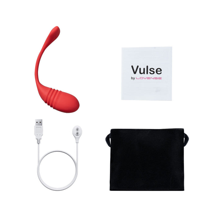 A red Lovense Vulse Thrusting and Vibrating Egg with a curved design, compatible with the Lovense app for long distance play, comes with a white charging cable with USB end, a small black storage pouch, and a rectangular white instruction manual featuring "Vulse by Lovense" in black and pink text.