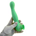 A gloved hand holds the mint green Luscious Licker Double Ended Licking & G-Spot Vibrator by Nasstoys, featuring a slightly curved design and a smooth finish. This powerful massager boasts a wider base with a circular opening and a shiny accent ring near the bottom. The glove is white with black polka dots, adding to the discreet thrills.