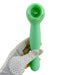 A gloved hand holds the Nasstoys Luscious Licker Double Ended Licking & G-Spot Vibrator in mint green, featuring a circular head and a sleek, ergonomic handle. The white glove with black polka dots contrasts against the plain white background, emphasizing the device's silky silicone finish.