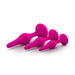 Three pink, satin-smooth silicone anal plugs of varying sizes are aligned in a row against a white background. Each plug has a bulbous middle section and a flared, rounded base designed for safety and ease of handling—perfectly embodying the Blush Luxe Beginner 3 Plug Anal Trainer Set - Various Colors.