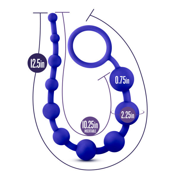 The Luxe Beginner Ultra Slim Silicone Anal Beads by Blush is a set featuring purple beads made from silky silicone, complete with an attached ring. These phthalate-free beads gradually range in size from 0.75 inches to 2.25 inches, offering a total length of 12.5 inches, with 10.25 inches being insertable.