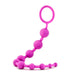 The Luxe Beginner Ultra Slim Silicone Anal Beads by Blush are body-safe and feature bright purple, linearly connected beads with a loop handle at the end. The beads range in size from small to large and can be bent to form a semi-circular shape.