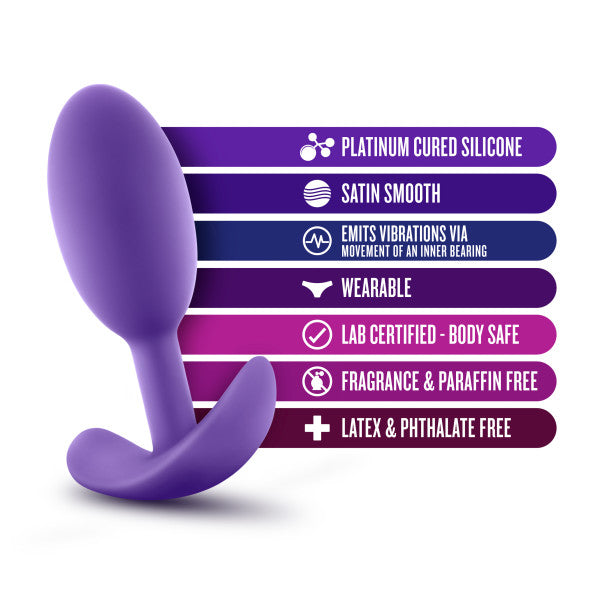 A Luxe Medium Wearable Silicone Vibra Slim Plug - Purple by Blush, featuring a rounded shape and handle at the base, is displayed. This product is made from platinum cured silicone with a satin smooth finish and emits vibrations via an inner bearing. It is wearable, lab certified body safe, fragrance & paraffin-free, as well as latex & phthalate free.