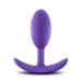 The Luxe Medium Wearable Silicone Vibra Slim Plug - Purple by Blush is a purple silicone anal plug featuring a rounded tip and a flared, curved base for safe insertion and easy removal. The ergonomic design of the base ensures comfort during use, preventing over-insertion.