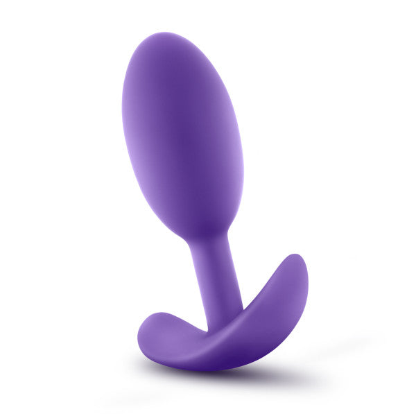 A purple silicone anal plug with a curved base designed for comfortable insertion and removal. The Luxe Medium Wearable Silicone Vibra Slim Plug by Blush has a smooth, tapered shape for easy use.