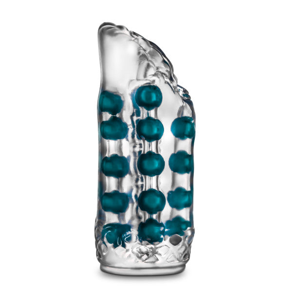 The M For Men Ribbed See Through Super Stroker by Blush is a clear, textured cylindrical object made of glass or plastic, featuring rows of teal, spherical beads embedded inside. It offers a realistic feel and is vertically oriented with intricate detailing and a slightly irregular shape at the top.