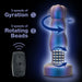 An image of the Matrix Vibrating Gyrating Rimming Butt Plug with Remote - Blue from Blush. The metallic-looking device, accompanied by a wireless remote control, showcases its various rotational and gyration features with text highlighting "5 speeds of Gyration" and "5 speeds of Rotating Beads," using graphic arrows to depict the movement directions.