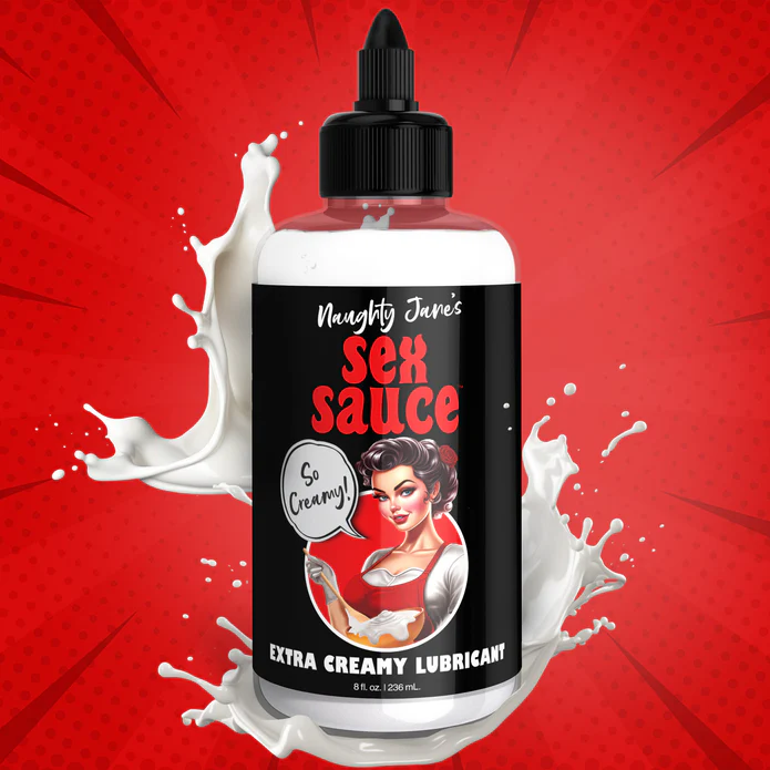 A bottle of "Naughty Jane's Creamy Cum Sex Sauce Lubricant" from XR Brands is displayed against a vibrant red background with splashes of white liquid. The label showcases a retro-style illustration of a woman, featuring the text "So Creamy!" in a speech bubble.