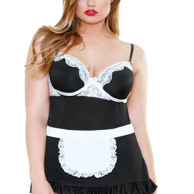 A woman is wearing the Night Service French Maid Costume 3X4X by Fantasy Lingerie. The ensemble includes a camisole with white lace trim, a small apron, and stockings with garters. She has long hair and is wearing red lipstick, embodying the allure of a night service maid.