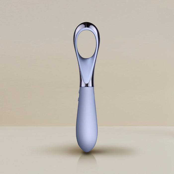 A sleek, modern Niya N3 Easy Grip Finger Loop Bullet Vibrator by Rocks Off features a polished metal loop and a soft-touch, light gray handle, standing upright against a neutral background. The minimalist design is both functional and aesthetically pleasing, reminiscent of the elegance found in high-end waterproof devices.