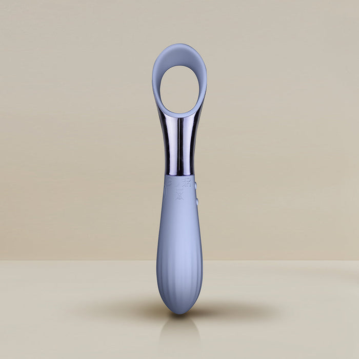 Image of a sleek, modern Niya N3 Easy Grip Finger Loop Bullet Vibrator with a grey ergonomic handle and a shiny metallic tip. The handle is designed for comfort and features a subtle ridged pattern for better grip, making it nearly waterproof. The background is a plain light beige surface and wall.