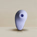 The Niya N6 Ergonomic Easy Grip Clitoral Air Stimulator Vibrator by Rocks Off boasts a sleek and minimalist pebble-shaped design with a smooth, matte finish in a light lavender hue. It features a prominent circular indentation near the top for clitoral suction. The background displays a gradient of beige tones, enhancing its clean and modern aesthetic.