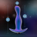 The Odyssey Vibrating Silicone Prostate Massager & Butt Plug by Blush features a contoured, iridescent texture that stands out against a galaxy-themed backdrop, inviting anal exploration. The dimensions are 5 inches in height, with an insertable length of 4.25 inches and a width of 1.25 inches.