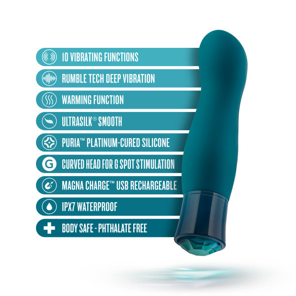 The Oh My Gem Fierce Blue Topaz Warming G-Spot Vibrator from Blush is displayed in a captivating teal color with a distinct curved tip. Adjacent to the image, text highlights its features: 10 vibrating functions, Rumble Tech Deep Vibration, warming function, Ultrasilk smoothness, Puria platinum-cured silicone that is phthalate-free, USB rechargeable, waterproof, and body-safe.